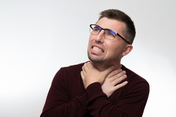 Handsome man wearing glasses over isolated background touching painful neck, sore throat from flu, cold and infection