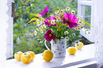 Bouquet of flowers of window sill in countryside
