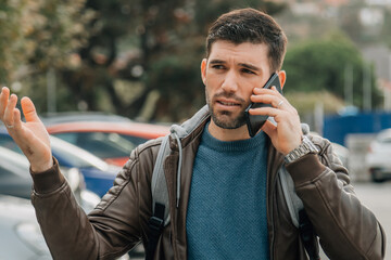 adult man talking on mobile phone in the street