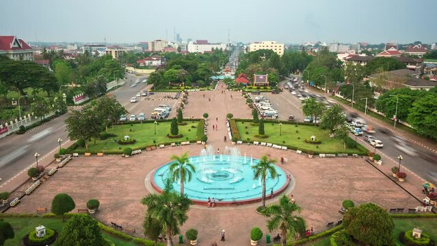 Time lapse view of people and traffic at Patuxay Park in Vientiane, the capital and largest city of Laos, zoom out. 
