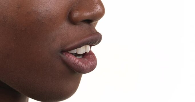 Side view profile of a black woman mouth shouting. Isolated on a white background. Close up.