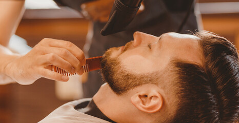 Banner Barbershop concept, vintage color. Portrait man in haircut salon, master working hair styling
