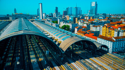 Aerial view of the station where trains arrive. An old arched structure made of metal and glass...