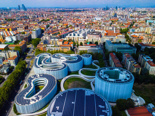 Aerial view of solar panels on the roof. The new campus of the SDA Bocconi School of Management is a modern building with classrooms. Colorful sky at sunset. Ecological energy. Milan Italy 09:2022