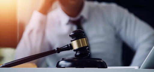 Male lawyer working with contract papers and wooden gavel on tabel in courtroom. justice and law ,attorney, court judge, concept.