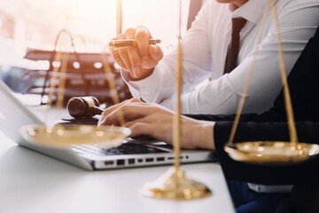 Fototapeta premium Male lawyer working with contract papers and wooden gavel on tabel in courtroom. justice and law ,attorney, court judge, concept.
