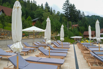 Sunbeds with mattresses near the pool in the Ukrainian Carpathians