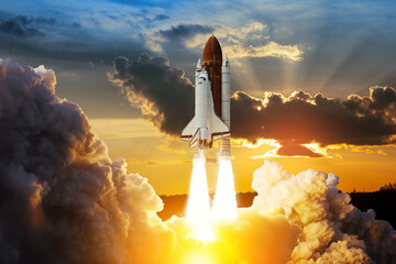 Spaceship lift off. Space shuttle with smoke and blast takes off into space on a background of...
