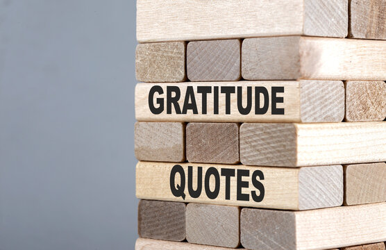 The text on the wooden blocks GRATITUDE QUOTES