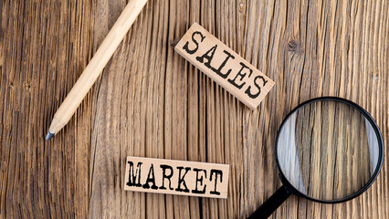 SALES MARKET words on wooden building blocks on the wooden background