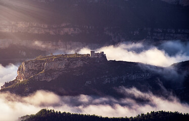 A castle looms out of the fog on a winter morning