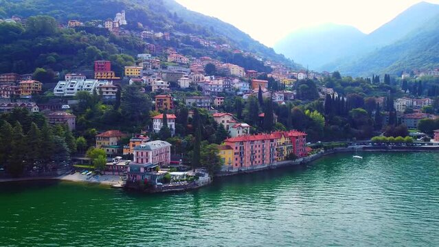 Aerial view of Lake Como. city ​​center. A local ferry arrives in the city. Bell tower. Tourism and romance. Mountains around the lake. Red roofs. Green Planet. Sailing yacht. Italy, Bellano, 09.2022