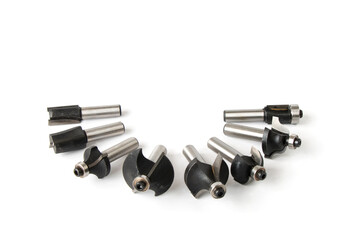 set of milling cutters for processing wooden products with a joiner's hand power tool, on a white...