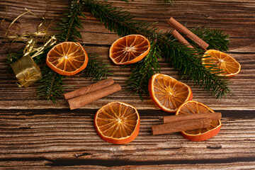 Wooden table with dried orange slices and cinnamon