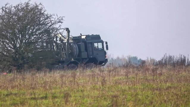 British army MAN HX77 8x8 with cargo in action traversing rough ground on a military exercise