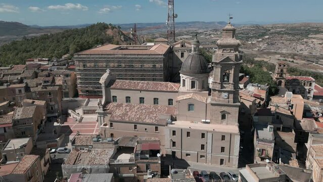 flying counter clockwise around church at top of hill town of Caltagirone Sicily