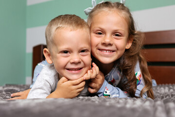 Brother And Sister Relaxing Together In Bed