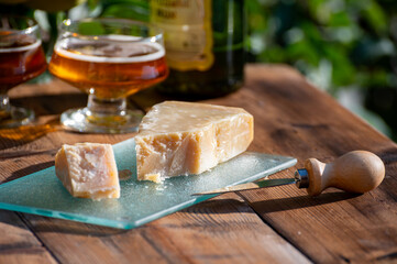 Cheese pairing with drinks,  parmigiano reggiano or parmesan cheese and French apple cider served outdoor