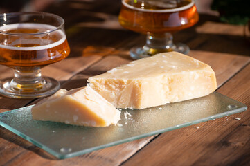 Italian cheese collection, piece of old parmigiano reggiano or parmesan cheese made from cow milk in Parma, Italy