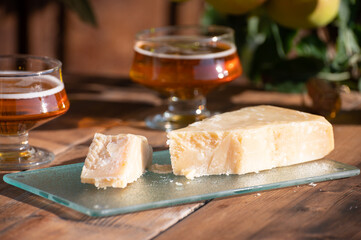 Cheese pairing with drinks,  parmigiano reggiano or parmesan cheese and French apple cider served outdoor