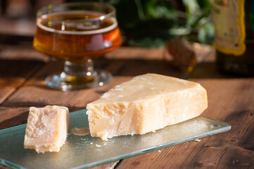 Cheese pairing with drinks,  parmigiano reggiano or parmesan cheese and French apple cider served outdoor