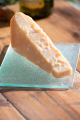 Italian cheese collection, piece of old parmigiano reggiano or parmesan cheese made from cow milk in Parma, Italy