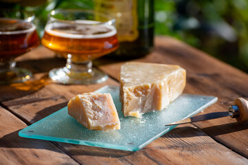 Cheese pairing with drinks,  parmigiano reggiano or parmesan cheese and French apple cider served outdoor