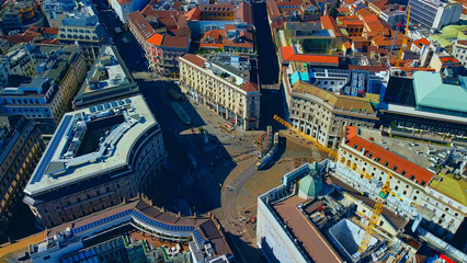 Aerial view of the city. Cars move around the city during the day. City life piazza Cordusio. Modern architecture. City traffic.
A short flight showing the skyscrapers. Milan. Italy, 10.2022 - obrazy, fototapety, plakaty