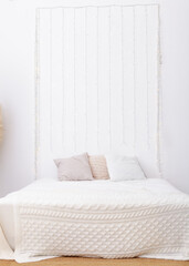 headboard with multi-colored pillows in the bedroom