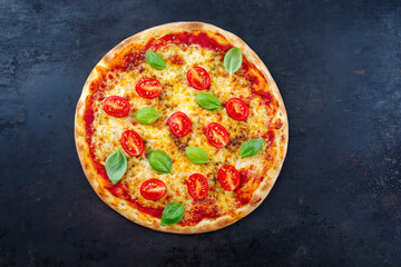Traditional Neapolitan Italian pizza margherita with tomatoes and mozzarella served as top view on...