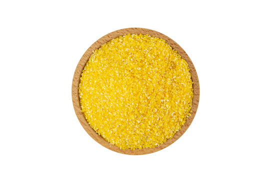 corn grits in wooden bowl isolated on white background. nutrition. food ingredient.