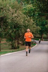 Athletic young man running in nature. Healthy lifestyle