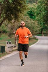 Athletic young man running in nature. Healthy lifestyle