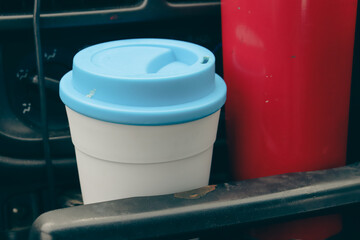 travel coffee mugs in cup holder of car
