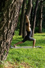 Hispanic practicing yoga in the forest