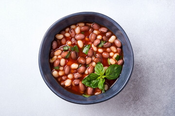 Bowl of vegetarian healthy meal with beans and tomato sauce