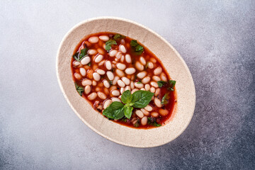 Bowl of vegetarian healthy meal with beans and tomato sauce