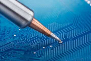 soldering electronic components onto the PCB. Electronics repair and digital technology.