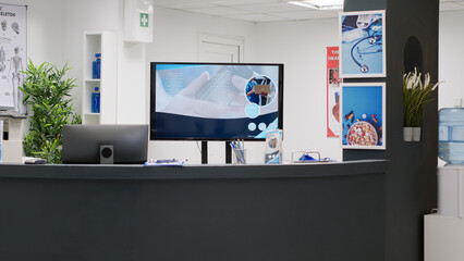 Empty reception desk with waiting room in clinic lobby, used for patients to attend medical checkup visit appointment with specialists. Waiting room at private health facility center.