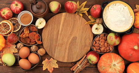 Kitchen background with ingredients for pumpkin and apple pies recipe, food preparation concept, cooking pies with spices, nuts, flour, eggs and pumpkin, apples for Thanksgiving,