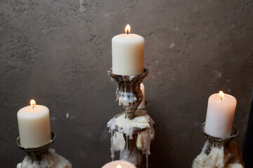 Group of evil candles burning in the darkness and copy space on wooden background. Black magic...