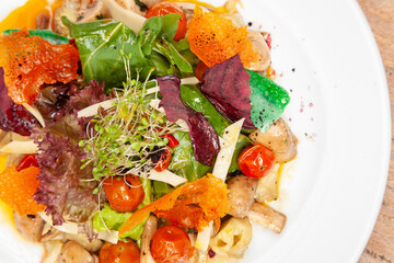 salads on a white plate with a light wood background