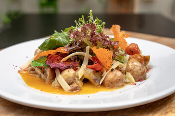 salads on a white plate with a light wood background