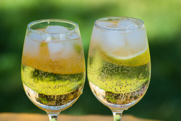 glasses with lemon cocktail with slices inside