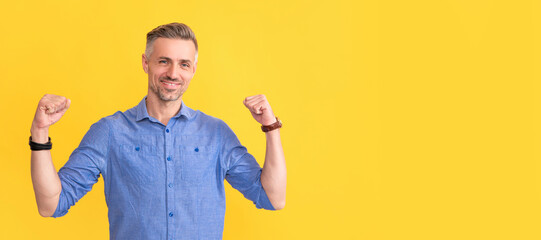 happy successful man with wristwatch on yellow background, success. Man face portrait, banner with...
