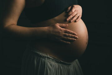 Pregnant woman holding her belly
