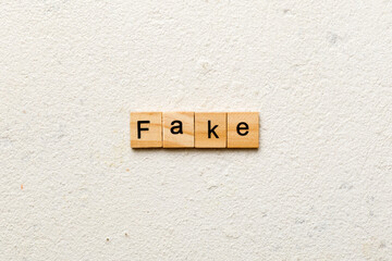 Fake word written on wood block. Fake text on cement table for your desing, concept