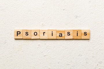 Psoriasis word written on wood block. Psoriasis text on table, concept
