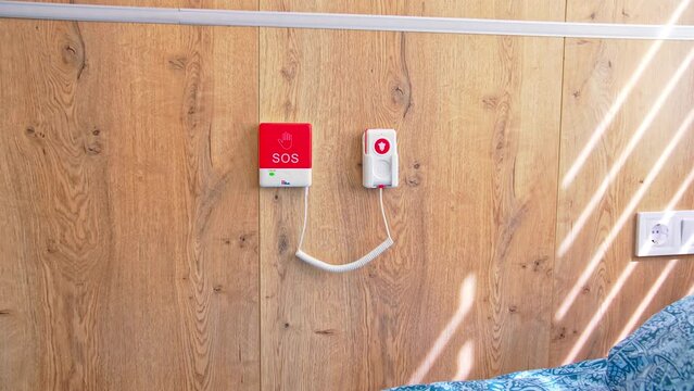 Emergency SOS button on the wall near the bed in postpartum intensive care unit. Close up. Equipment in maternity hospital.