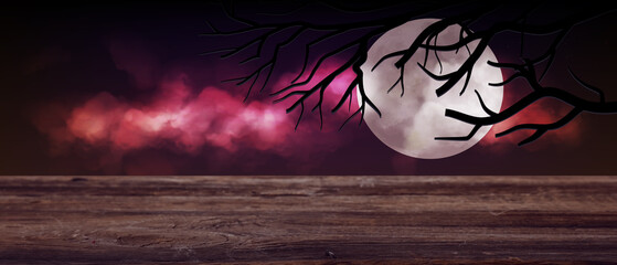 Halloween banner with empty wooden table outdoors at night
